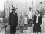 A family with three young girls pose for an outdoor photograph by Basil Clemons 1887-1964