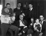 A family poses informally around a sofa by Basil Clemons 1887-1964