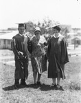 A woman stands with two graduates by Basil Clemons 1887-1964