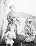 A family sitting next to a tent by Basil Clemons 1887-1964