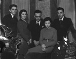 A group of two young women and three young men posed around a sofa by Basil Clemons 1887-1964