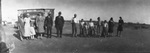 A family poses in a long line by Basil Clemons 1887-1964