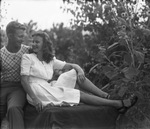 A couple sitting in nature by Basil Clemons 1887-1964