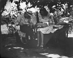 A couple sitting outside by Basil Clemons 1887-1964