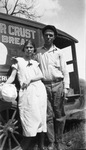 A couple leaning against a car by Basil Clemons 1887-1964