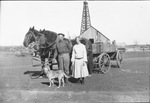 A family and a horse drawn wagon by Basil Clemons 1887-1964