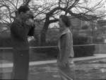 A man photographing his spouse by Basil Clemons 1887-1964