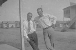 Two men leaning on a pole by Basil Clemons 1887-1964