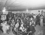 A large group of African Americans in a room by Basil Clemons 1887-1964