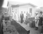 A group of men grilling outdoors by Basil Clemons 1887-1964