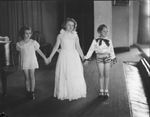 Three young female Davis Dancers performers standing on a stage by Basil Clemons 1887-1964