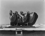 Four female costumed Davis Dancers performers on a roof by Basil Clemons 1887-1964