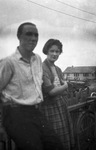 A couple leaning on a fence by Basil Clemons 1887-1964