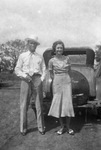 A couple next to a car by Basil Clemons 1887-1964