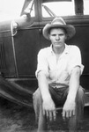 A man sitting on a car by Basil Clemons 1887-1964