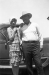 A couple in front of a car by Basil Clemons 1887-1964