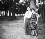 A couple leaning on a tree by Basil Clemons 1887-1964