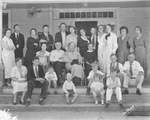 A large group of people, probably a family reunion, pose on a large front porch by Basil Clemons 1887-1964