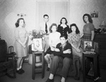 A group of young men and women, possibly siblings, posing in a living room by Basil Clemons 1887-1964