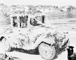 A flower draped car with two children and adult occupants in honor of 17th District American Legion Convention by Basil Clemons 1887-1964