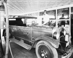 A man stands over a Nash car, Breckenridge, Texas by Basil Clemons 1887-1964