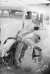 A wrecked car awaiting repair in a car repair shop, Breckenridge, Texas by Basil Clemons 1887-1964