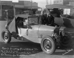 Mr. and Mrs. O.B. Stoker stand beside their roadster car, Breckenridge, Texas by Basil Clemons 1887-1964