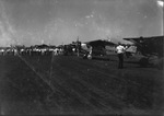 Large crowd of people standing on the tarmac of an airfield with several propeller-type airplanes, likely Breckenridge, Texas. by Basil Clemons 1887-1964