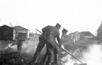 Two men working in an outdoor setting, location not identified by Basil Clemons 1887-1964