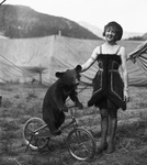 Female circus performer with a small bear cub by Basil Clemons 1887-1964