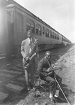 Two African American musicians with the "John Robinson's Circus" in front of the circus train by Basil Clemons 1887-1964