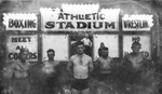 Boxers and wrestlers standing in front of an "Athletic Stadium" sign by Basil Clemons 1887-1964