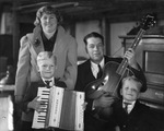 Musicians; family of four with musical instruments including piano, guitar, and accordion, Breckenridge, Texas by Basil Clemons 1887-1964