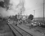 Circus; several teams of horses and men waiting beside a railroad track for the circus to arrive in town, Breckenridge, Texas by Basil Clemons 1887-1964