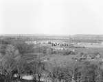 Aerial view of McCluskey oil pool, oil tanks, the settlement, and derricks on the landscape by Basil Clemons 1887-1964