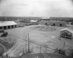 Oil and refining company buildings with nearby oil tanks and oil derricks scattered across landscape near Breckenridge, Texas, undated [ca. 1920s-1930s] by Basil Clemons 1887-1964