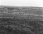 Open fields and hills with settlement in distant background near oil fields near Breckenridge, Texas by Basil Clemons 1887-1964