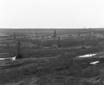 Oil derricks scattered across landscape, near Breckenridge, Texas [ca. 1920s] by Basil Clemons 1887-1964