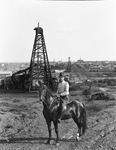 Judge Frank Roberts on horseback with oil derricks filling landscape in background by Basil Clemons 1887-1964