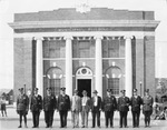 Municipal Building, with men in police uniforms and suits lined up in front, Breckenridge, Texas by Basil Clemons 1887-1964