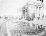 Lilly pond with three children nearby beside the Stephens County Courthouse by Basil Clemons 1887-1964