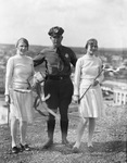 Two young women dressed alike standing next to a policeman, Breckenridge, Texas by Basil Clemons 1887-1964