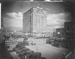 The Burch Hotel and downtown Breckenridge, Texas, with buildings draped in flags; Baum's Fashion Shop sign is in foreground by Basil Clemons 1887-1964