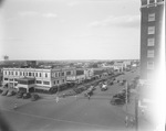 Downtown Breckenridge street showing Sager Hotel, Palace and National theaters, Johnson's Cafe, Alexander's Ice Cream, Texaco service station, and other storefronts, Breckenridge, Texas by Basil Clemons 1887-1964