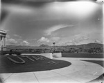 Cloudy skies and foothills with a Utah monument in foreground; location not identified; photograph not dated by Basil Clemons 1887-1964