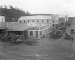 Street scene in Ellisville, Texas; C&D Grocery Co., AE and FS Hofues Industrial Realty and Oil Dealers, Ellisville Building and Realty Co., Waffle Kitchen, Garages by Basil Clemons 1887-1964