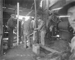 "Giving her the soop," oil field workers working with oil field machinery inside a shed, Breckenridge, Texas by Basil Clemons 1887-1964