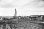 Oil field with numerous oil derricks next to a hospital building, Breckenridge, Texass by Basil Clemons 1887-1964