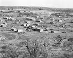 Settlement of wooden buildings and dirt roads near oil field, Breckenridge, Texas by Basil Clemons 1887-1964