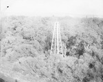 Oil field with derricks scattered among trees, undated by Basil Clemons 1887-1964